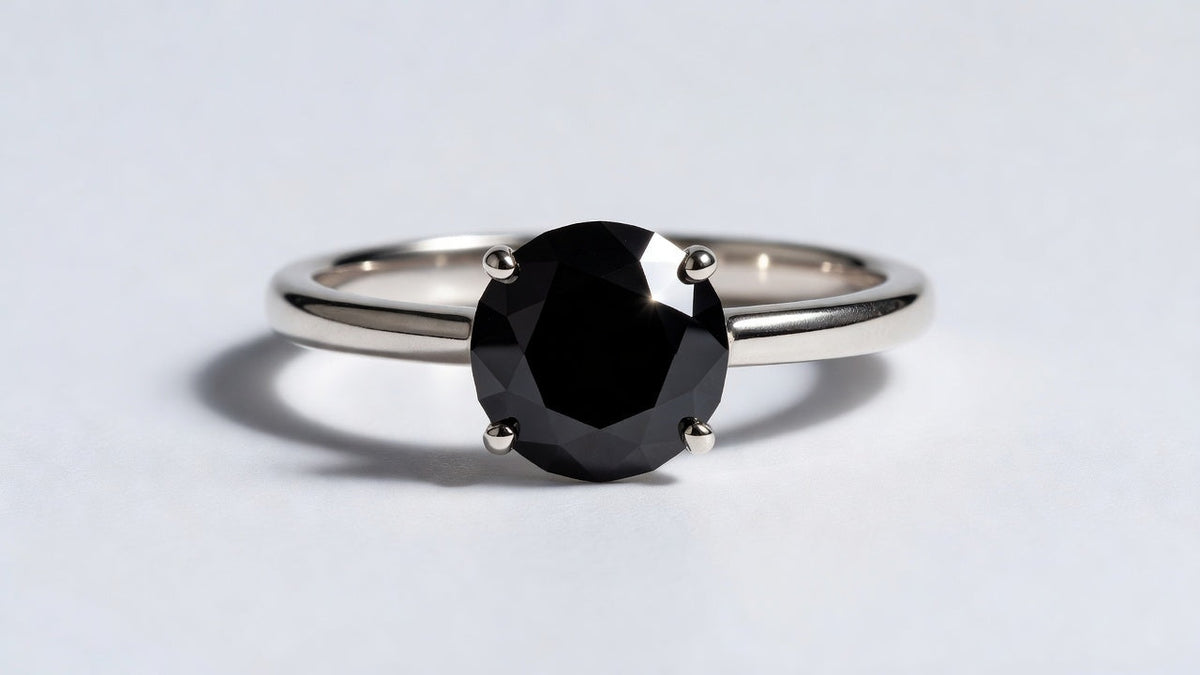 Black moissanite solitaire ring showing the opaque jet black stone with bright mirror-like surface reflections