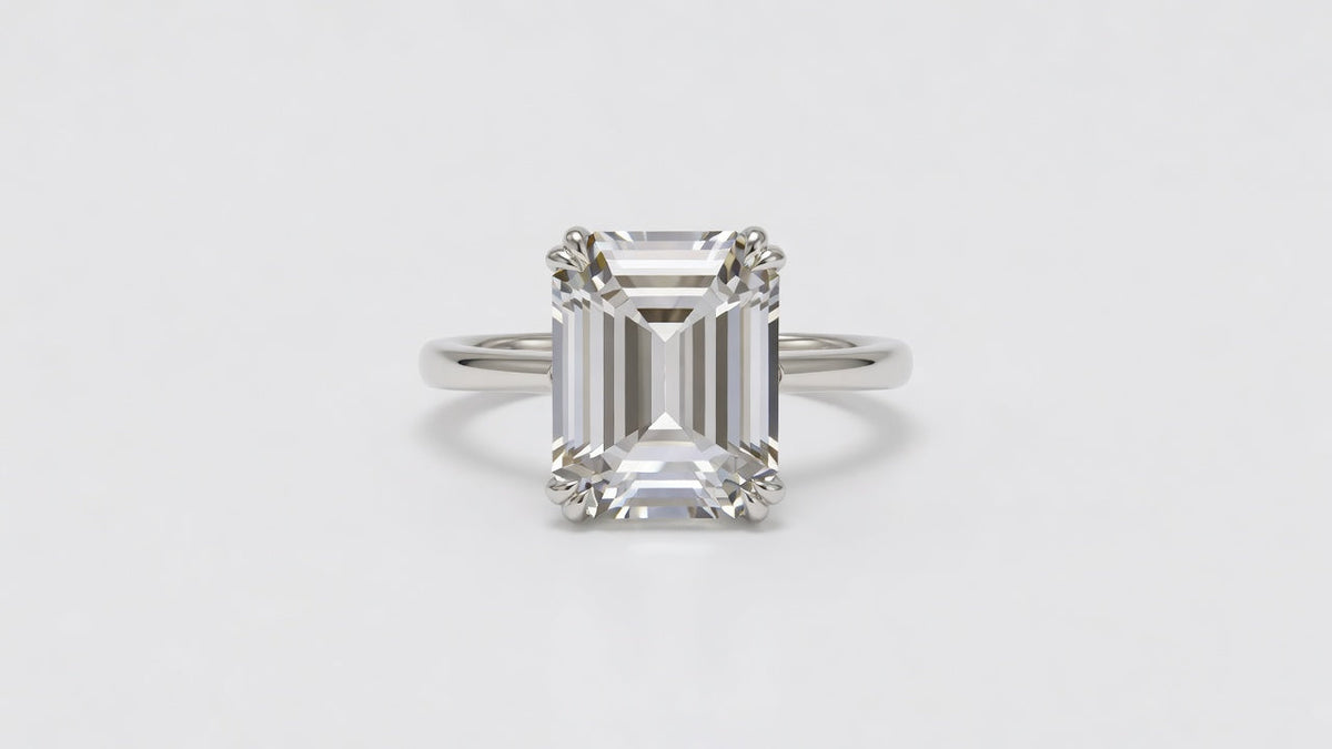 An emerald cut moissanite ring showing the long parallel step facets and open table
