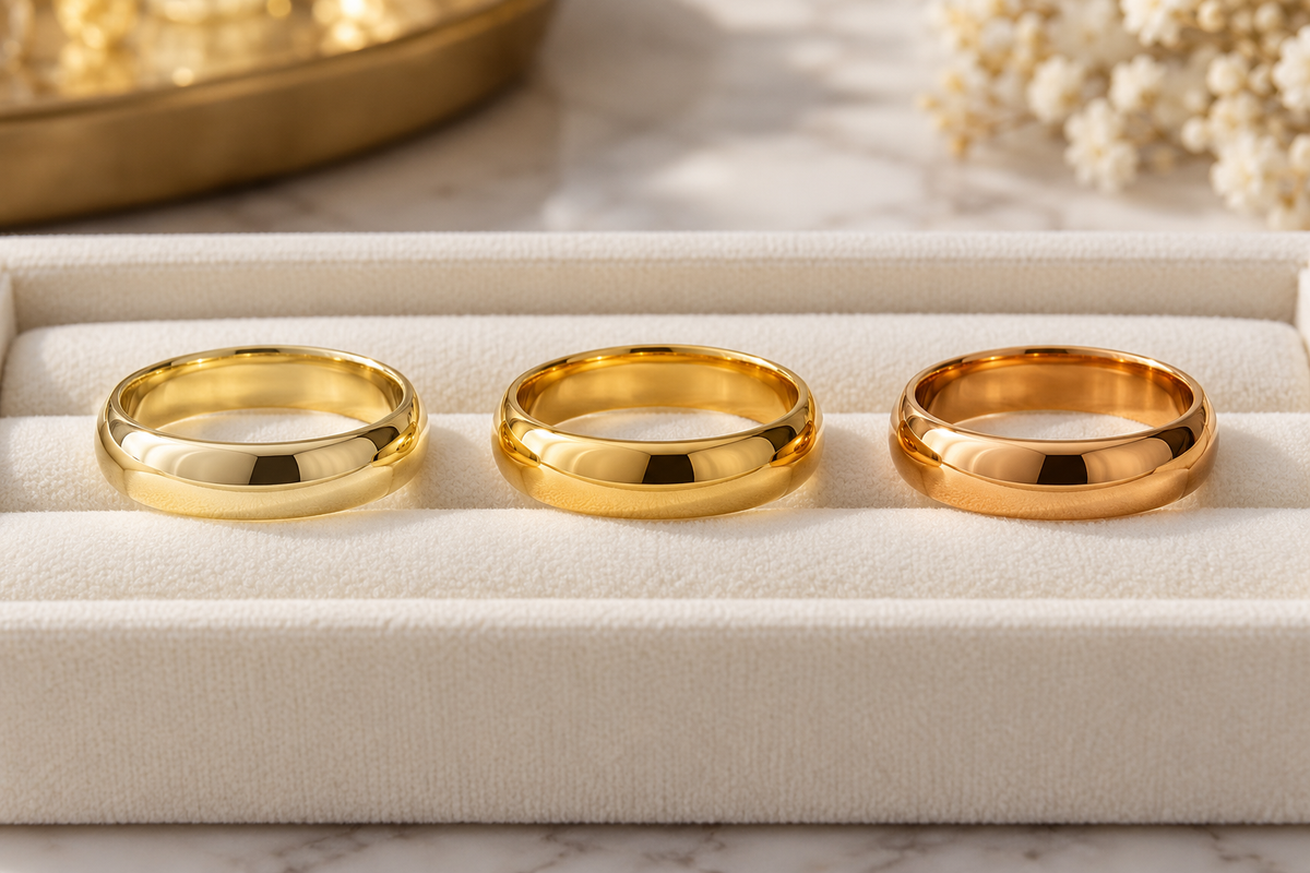 Three unbranded yellow-gold rings in subtly different tones