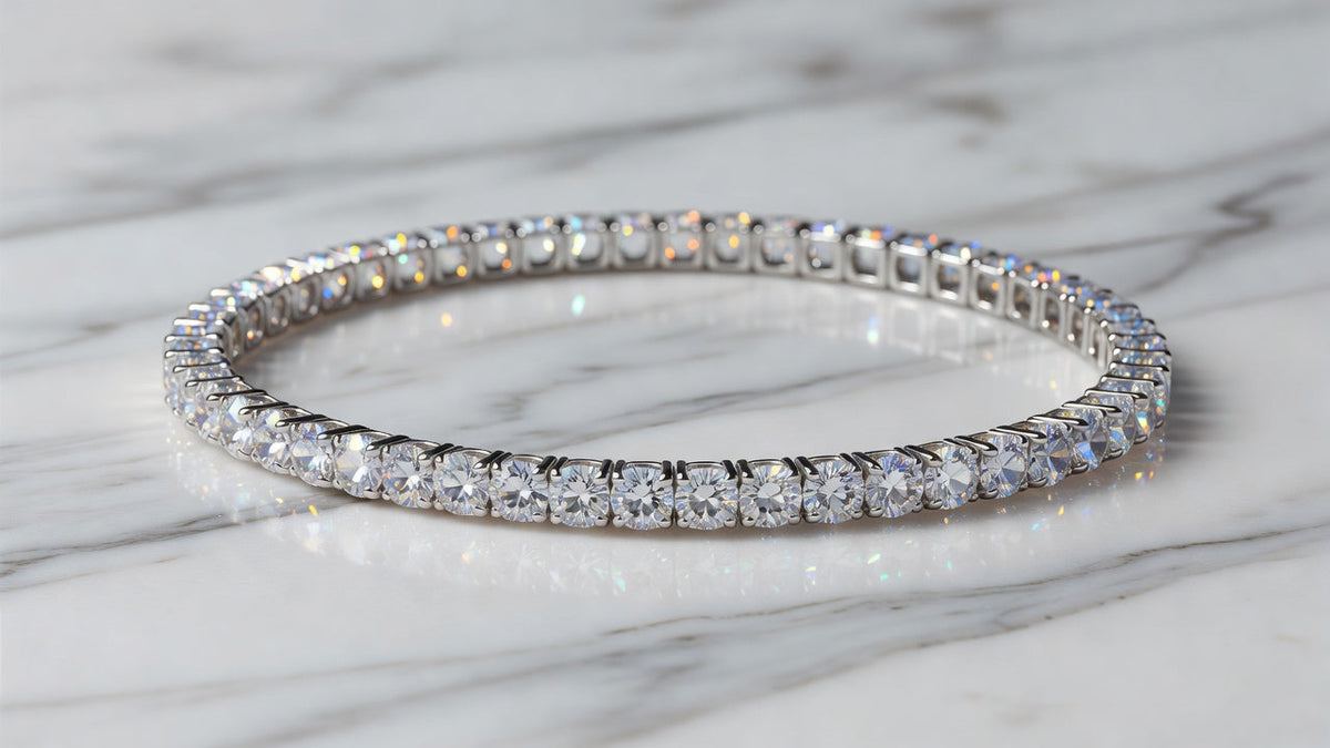 Moissanite tennis bracelet laid flat on white marble showing brilliant sparkle of each stone