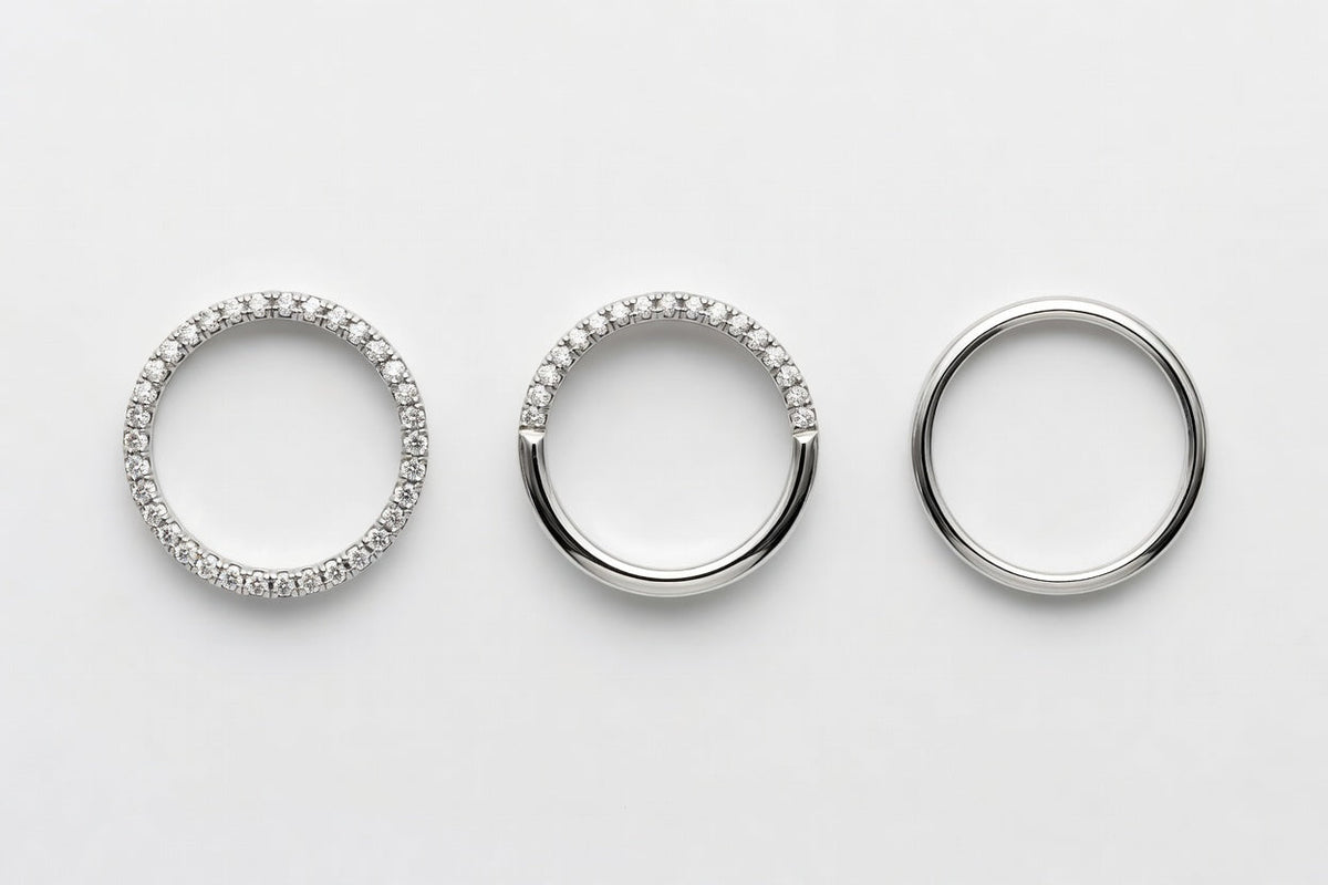 Overhead view of three wedding bands showing full eternity half eternity and plain metal styles