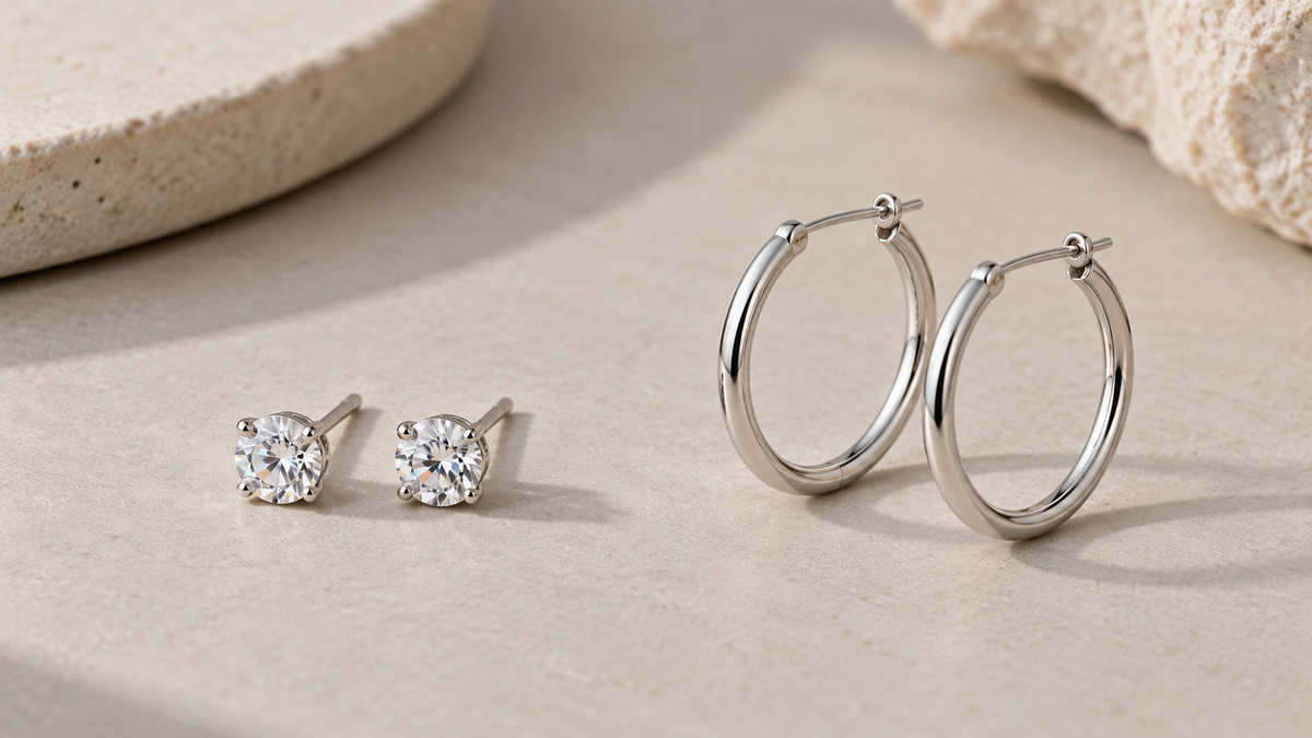 Small stud earrings and slim hoop earrings arranged side by side